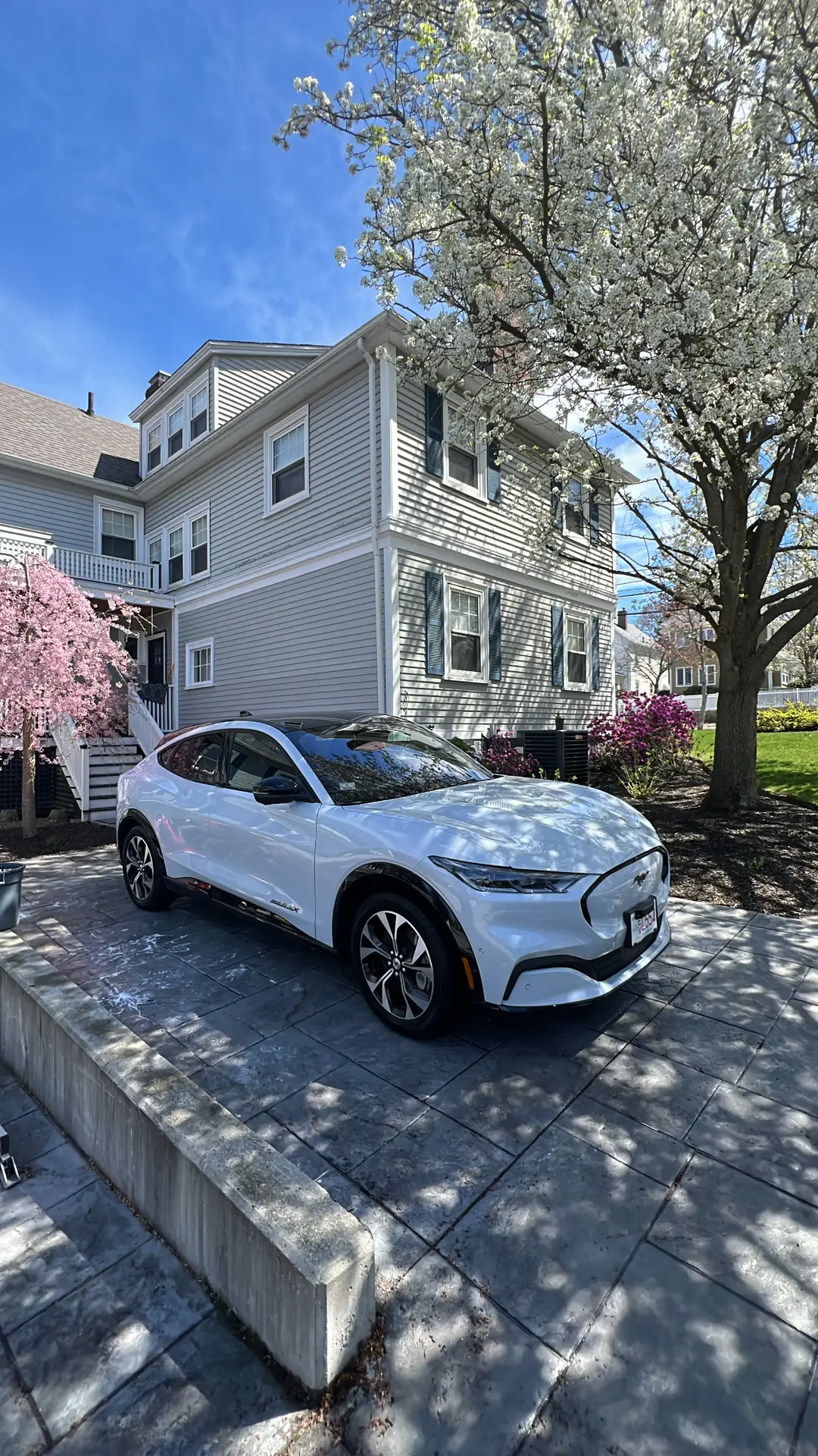 White crossover parked at a customer's home